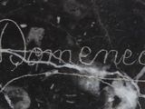 an image of a black and white photo of a marble slab with writing underneath it