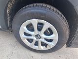 a dirty tire on the side of a car