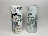 pair of chinese vases with asian characters on them on a white background