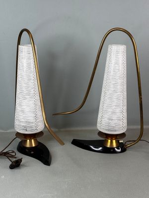 pair of brass and glass table lamps with white lampshads