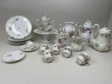 many different types of porcelain dishes and cups on the table