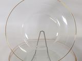 a glass plate with a gold rim and a glass bowl with a gold rim