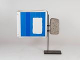 a blue and white sign on a metal stand