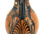 a black and orange vase sitting on a white surface