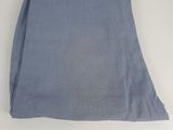 a blue towel folded on top of a white table