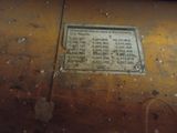 a sign on the side of a rusted building