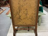 an image of a wooden chair in a room filled with furniture