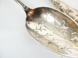 two spoons that are sitting next to each other on a table