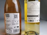 two bottles of wine sitting next to each other on a table