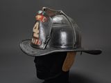 firefighters helmet on a mannequin head on a gray background