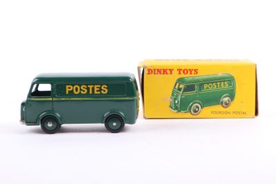 a green toy truck that is next to a box of postes