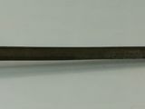 a knife that is laying on a white surface