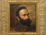 un tableau représentant un homme barbu dans un cadre en or