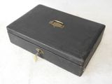 a black box with a lock on it on a white surface