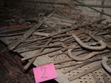 a pile of old rusty tools in a room