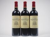 trois bouteilles de vin rouge posées l'une à côté de l'autre sur une surface blanche