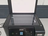 a printer sitting on top of a table next to a wall