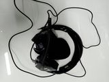 a pair of black headphones on a white surface