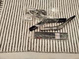 a pair of scissors and a remote on a striped rug