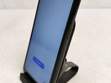 the back of a black samsung s9 phone with a blue screen