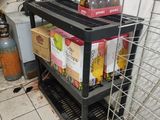 a metal rack with several boxes on it in a room