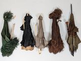 many different umbrellas hanging on a wall next to each other