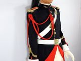 a man in a uniform that is standing next to a wall