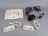 a nintendo game console with two controllers and a charger
