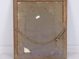 an old mirror with a rope hanging from it ' s side