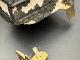 a small wooden box with a gold lid next to a broken piece of wood