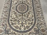 a large oriental rug with a floral design on a white ground