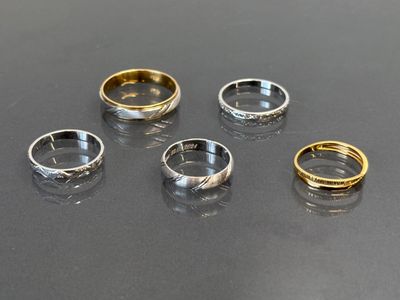 four different types of rings on a black surface
