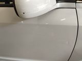 an image of a white car with a black stripe on the side