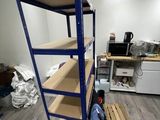a blue shelf in the middle of a room