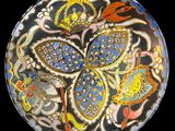 an image of a decorative plate with a flower design on it