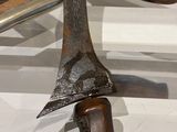 a knife and a knife holder hanging on a wall