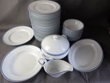 a lot of plates and cups that are on a table