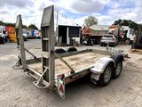 an image of a flatbed trailer in a parking lot
