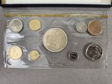 a box of coins with a picture of a man on it