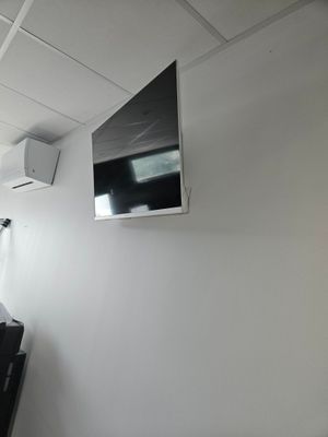 a flat screen tv mounted on the wall in a room