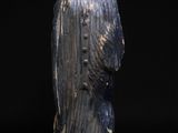 an old wooden statue of a man with a hat and robe