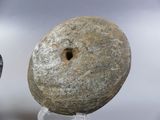 a stone object with a hole in the middle of it