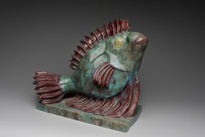 a sculpture of a fish that is sitting on a table