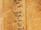 a piece of wood that has writing on it