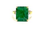 an emerald and diamond ring on a white background