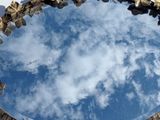 a mirror that has a reflection of a sky in it