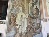 a large painting of a group of people in a building