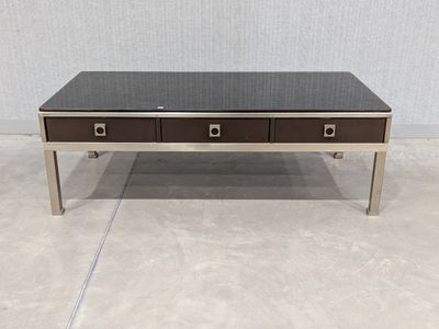 a coffee table with two drawers and a glass top