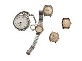 three watches and a watch bracelet are sitting next to each other