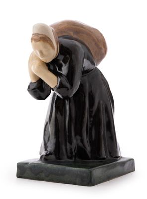 figurine of a woman in a black dress with a hat on her head
